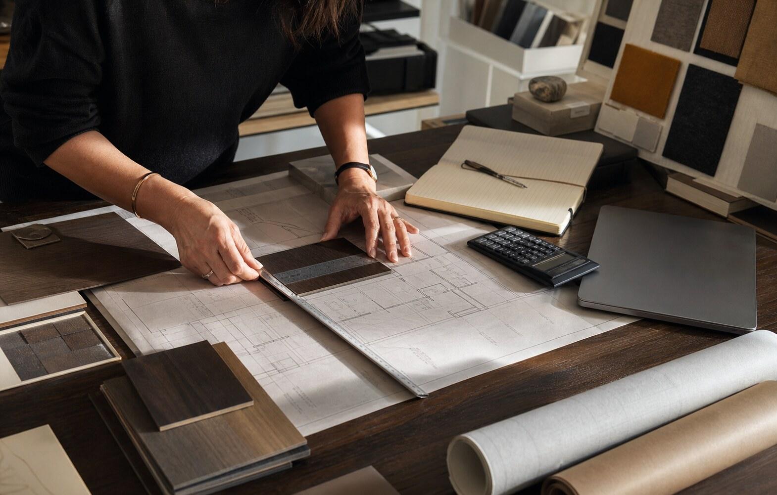 Contractor reviewing project plans, costs, and measurements